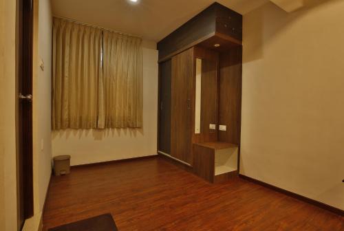 a room with a hallway with a wooden floor and a window at Hotel Ramtel inn in Madurai