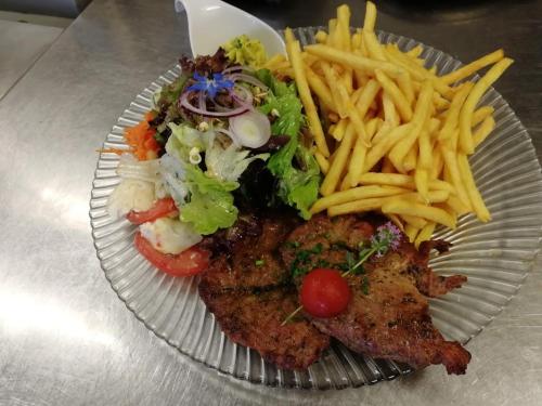 a plate of food with french fries and meat at Hotel Restaurant Albans Sonne in Bad Rippoldsau