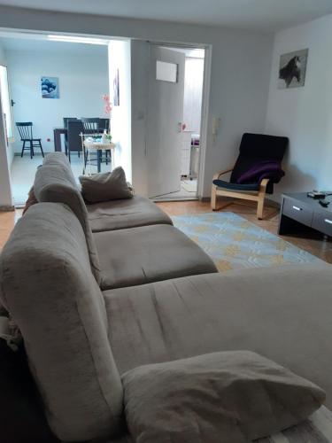 a large couch in a living room with a table at 2-Bed House - Garden Parking Pets in Viana do Castelo