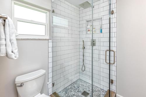 a bathroom with a shower with a glass door at Modern Home, Heated Pool, Close to Beaches! in Tarpon Springs