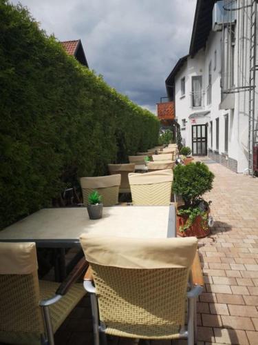 a row of tables and chairs on a patio at Landhotel Spessartruh in Frammersbach