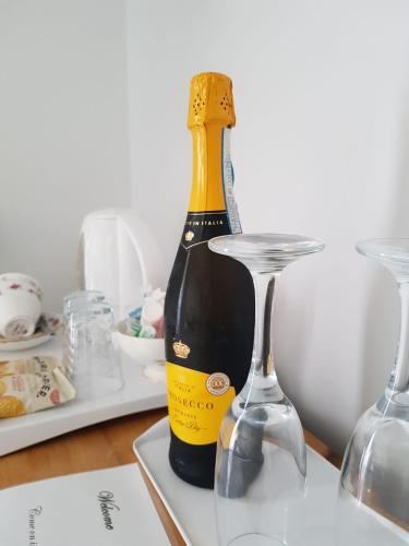 a bottle of champagne next to two glasses on a table at Park Dene Room only in Whitby