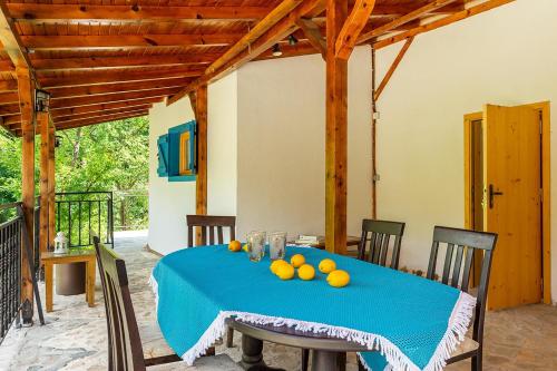 a table with a blue table cloth and fruit on it at Garmen Hills Guest Houses in Garmen