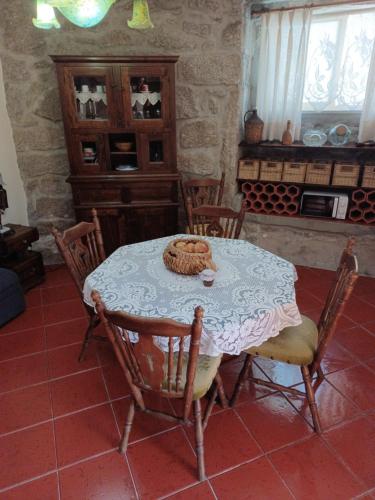 a table in a room with a table and chairs at Casa do Palheiro in Montalegre
