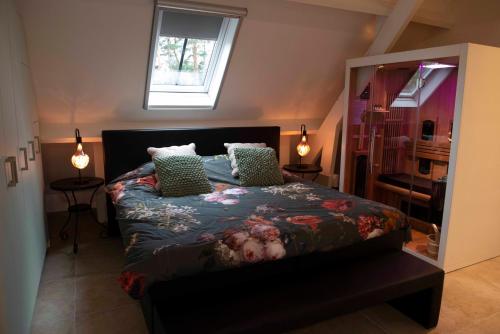 a bedroom with a bed with a floral comforter at StudioBeerse met Sauna Zwembad en Spa in Beerse