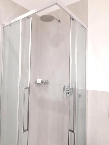 a shower with a glass door in a bathroom at RipamontiBnB in Milan