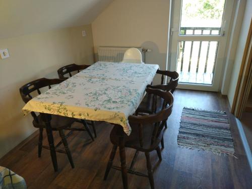 a dining room table with chairs and a table cloth at Bike Stop Duna in Dunaszentmiklós