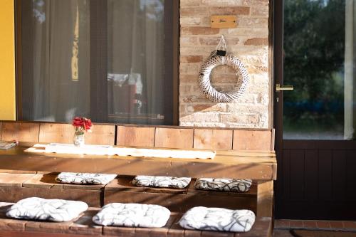 a row of white pillows sitting on a wooden table at La Dolce Vallata in Montefiore dellʼAso