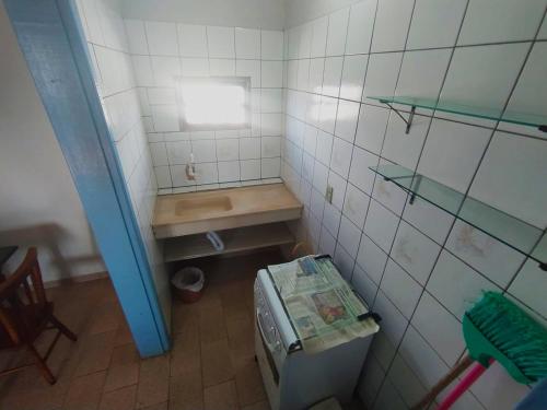 a small bathroom with a toilet and a sink at Pousada Colibris in Pinhal