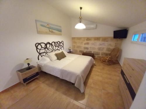 a bedroom with a large white bed in a room at SOBERANA JAVEA in Jávea
