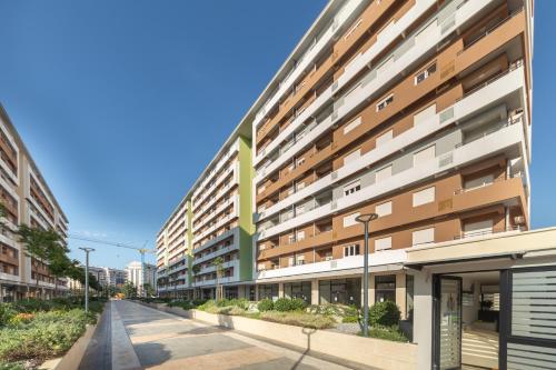 a building with a green sign on the side of it at Consulate in Podgorica