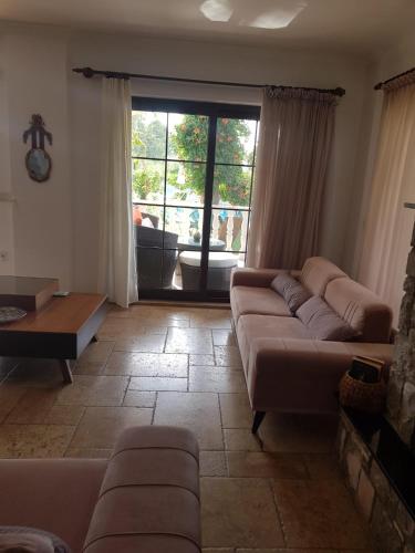 a living room with a couch and a table at Villa Bade in Dalyan