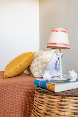 a lamp on a table with a book and a basket at Domaine de la Serve in Lancié