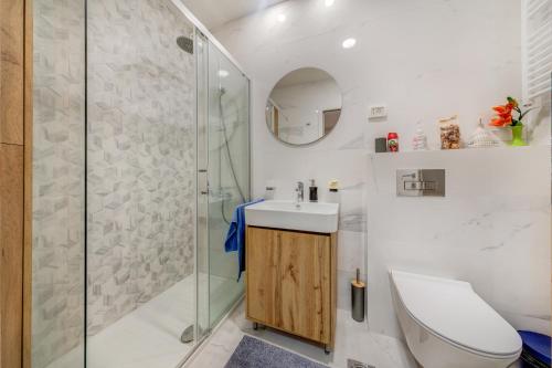 a bathroom with a shower and a toilet and a sink at Consulate in Podgorica