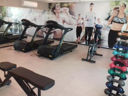 a group of people on exercise bikes in a gym at Acomodação Tranquila (Centro de Campos) in Campos dos Goytacazes