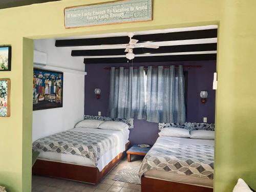 A bed or beds in a room at Villa Bougainvillea Aruba, the Tango Suite