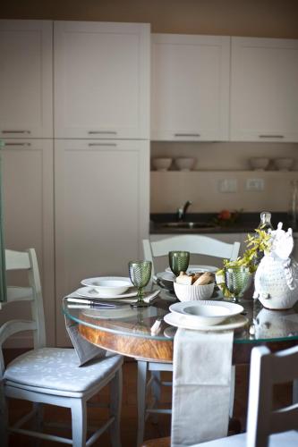 a dining room table with white plates and chairs at San Martinello in Perugia