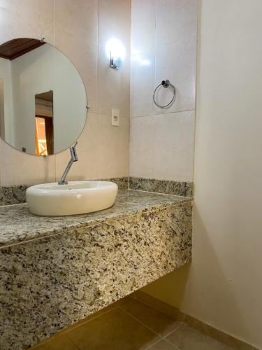 a bathroom with a sink and a mirror at Pousada Tetiaroa in Barra Grande