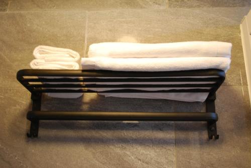 a pile of towels on a rack in a bathroom at 墾丁花漾年 小Villa in Hengchun South Gate