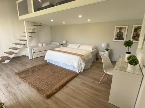 a bedroom with a bed and a spiral staircase at Arafo Sunset Villa in Arafo