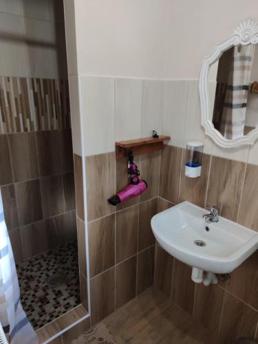 a bathroom with a sink and a shower at András penzión in Krásnohorské Podhradie