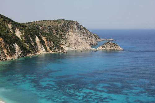 an island in the middle of the ocean at Petani Bay Hotel - Adults Only in Vovikes