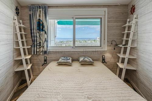 a bedroom with a large bed and a window at Captain Americas Apartment in Playa de las Americas