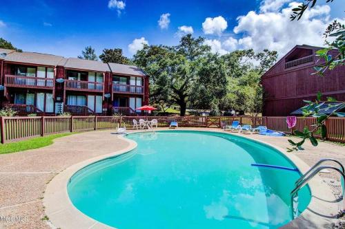 a swimming pool in front of a building at Lakeside Villa - Quite Location, walk to the pool and to the Country Club in Diamondhead
