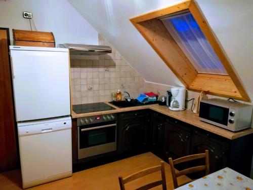 een keuken met een witte koelkast en een fornuis top oven bij Gästehaus Deisl in Mariapfarr