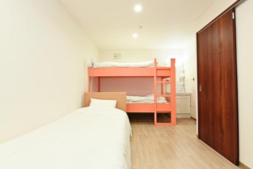 a bedroom with two bunk beds and a bed at Heights N7 / Vacation STAY 7569 in Sapporo