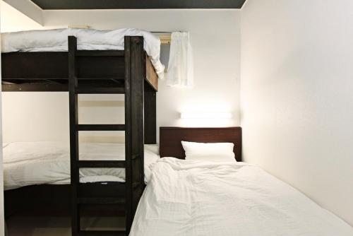 a bedroom with two bunk beds and a ladder at Heights N7 / Vacation STAY 7573 in Sapporo