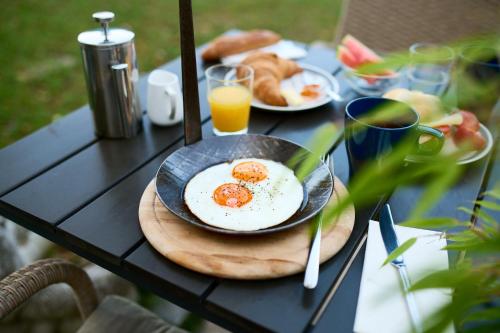 a table with two fried eggs on a plate at Bergbude in Oberferlach