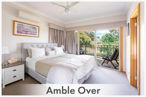 a bedroom with a large bed and a balcony at Amble at Hahndorf in Hahndorf