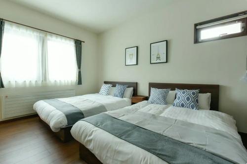 Ένα ή περισσότερα κρεβάτια σε δωμάτιο στο Hostel Sapporo Hachijo / Vacation STAY 79567