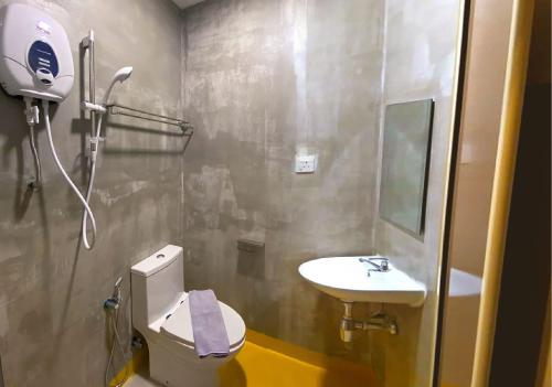 a bathroom with a toilet and a sink at Hotel EC KIP Sentral KLIA 1 - KLIA 2 in Sepang