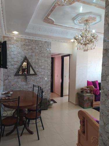 a dining room with a table and a chandelier at حدائق إفران in Ifrane