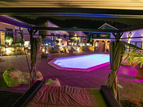 a swimming pool in a backyard at night at FBA Village in Bundenthal