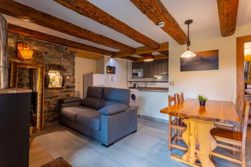 a living room with a couch and a table at Balcon del Pirineo Rural Ordesa in Buesa