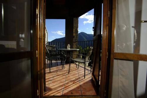 a view of a balcony with a table and chairs at Balcon del Pirineo Rural Ordesa in Buesa