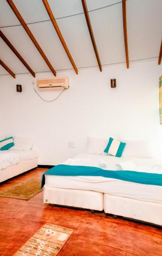 a bedroom with a large white bed in a room at Sarada Beach Resort Yala in Tissamaharama