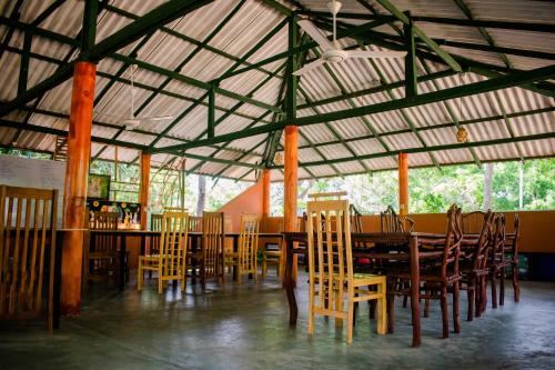 a dining room with a table and chairs at Sarada Beach Resort Yala in Tissamaharama