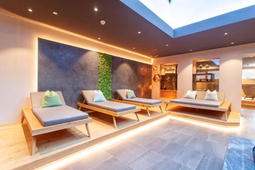 a room with two couches and a plant at Wellnesshotel Warther Hof in Warth am Arlberg