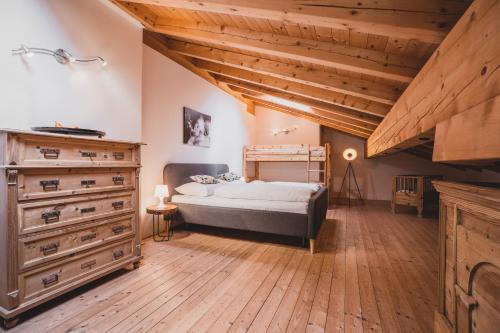 a bedroom with a bed and a dresser at Ferienwohnungen Wiesbauer in Schenna