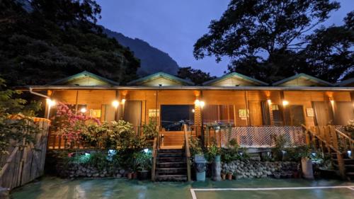 a home at night with lights on at Golden Leather Carving Studio in Leye