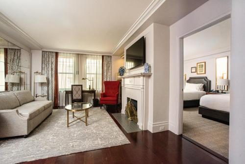 a living room with a couch and a fireplace at InterContinental New York Barclay Hotel by IHG in New York