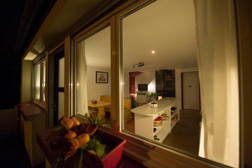 a view of a kitchen from a window of a room at Le Cocon du Village Gérardmer in Gérardmer