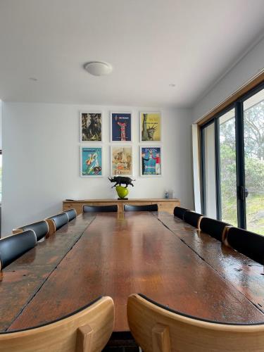 a large conference room with a large table and chairs at Hill Top Retreat in Nubeena