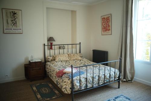 a bedroom with a bed with a little girl on it at Grand-Varennes in Serbonnes
