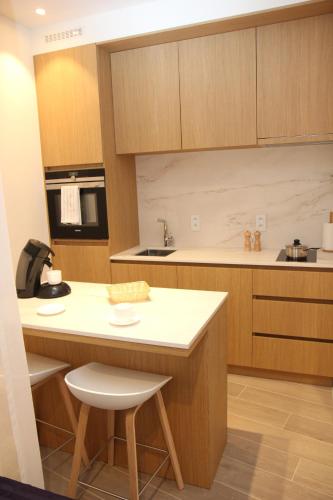 a kitchen with wooden cabinets and a white counter top at STUDIO61 in Ghent