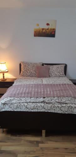 a bedroom with a bed with a pink and white blanket at Pensiunea turistica Retreat Belvedere in Vadul lui Carol II